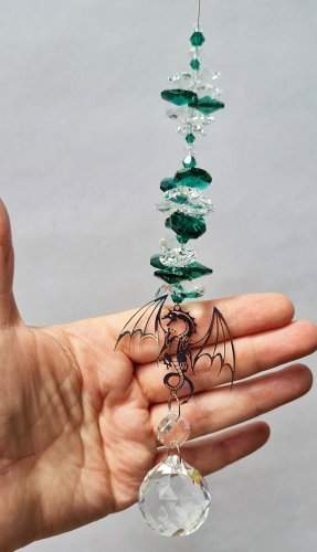 filigree dragon suncatcher in hand