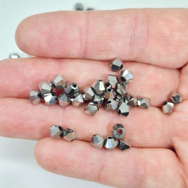 6mm silver bicone crystal beads in hand