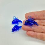 small blown glass blue dolphin with 2 hooks
